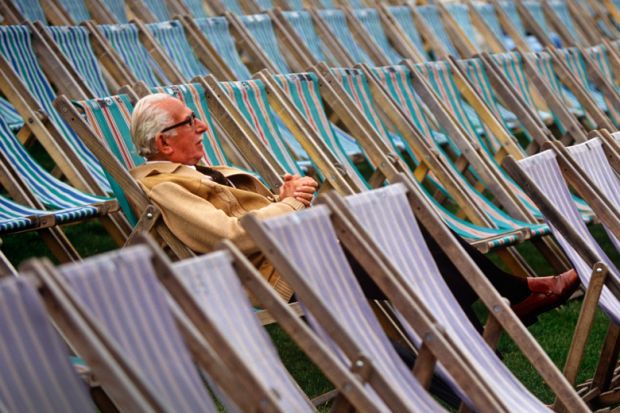 Elderly man sitting alone in rows of deckchairs Elderly man sitting alone in rows of deckchairs