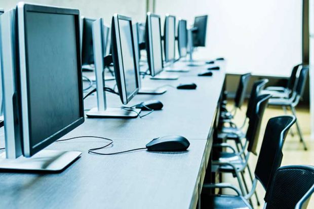 Empty computer lab illustrating online education platform edX sale to 2U