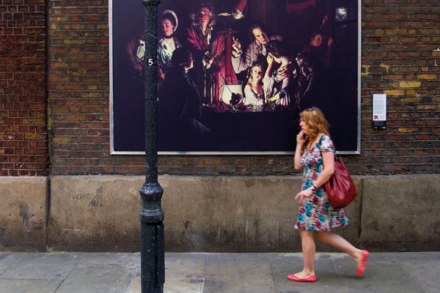 A reproduction of ‘An Experiment on a Bird in the Air Pump’ by Joseph Wright of Derby is displayed in Soho in central London, 2007