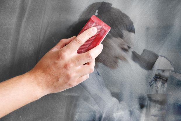 An image of a woman looking through a microscope being erased on a blackboard. To illustrate the rise in teaching-only contracts, limiting career opportunities for research-focused staff. An image of a woman looking through a microscope being erased on a blackboard. To illustrate the rise in teaching-only contracts, limiting career opportunities for research-focused staff.