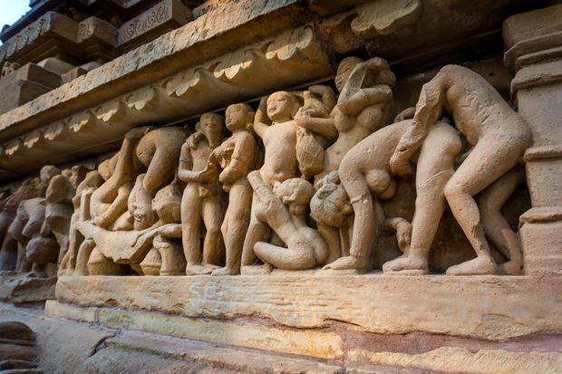 Erotic scene on sculptured surface of famous indian temple of Khajuraho