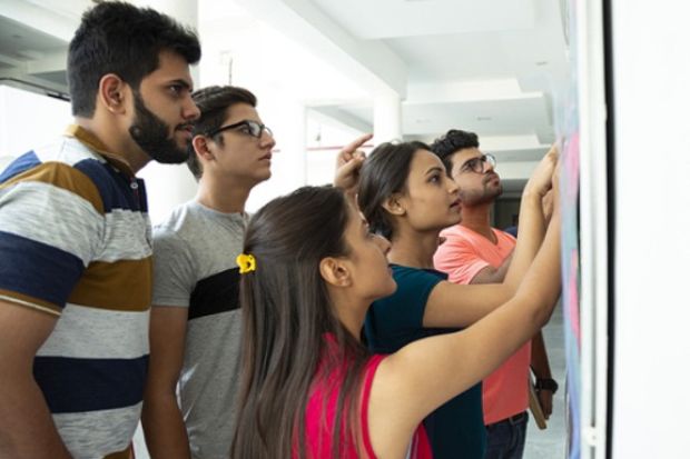 Indian students look at their exam results Indian students look at their exam results