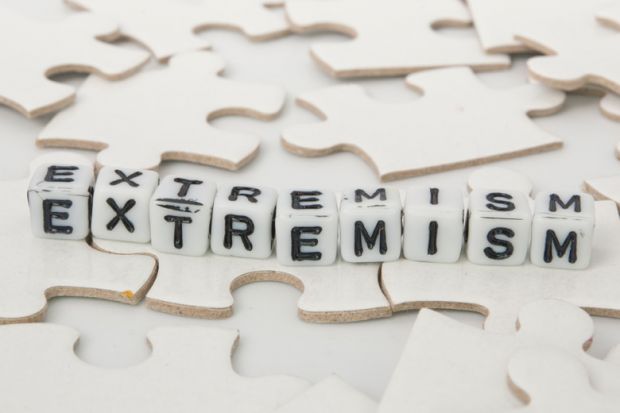 'Extremism' spelled out in letter blocks on jigsaw