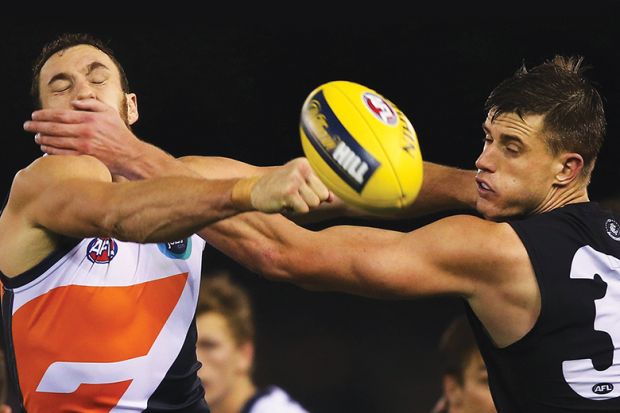 Australian Rules football players clash over ball, illustrating gag clause in redundancy contracts
