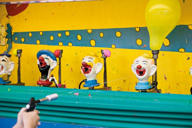 Shooting clown heads at the fairground