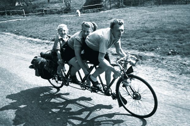 Family riding three-seat bicycle Family riding three-seat bicycle
