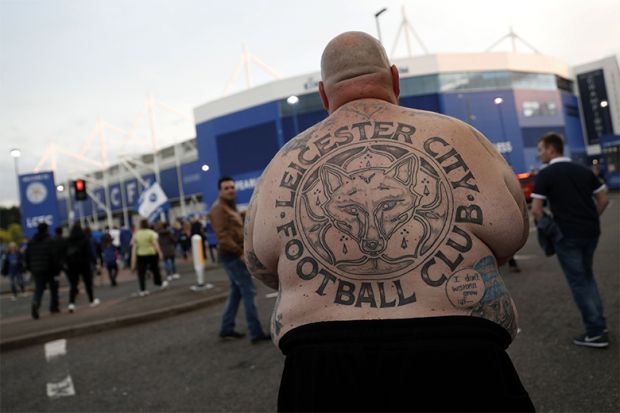 Shirtless football fan with Leicester City back tattoo