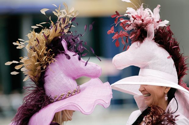 Two women wearing fancy hats