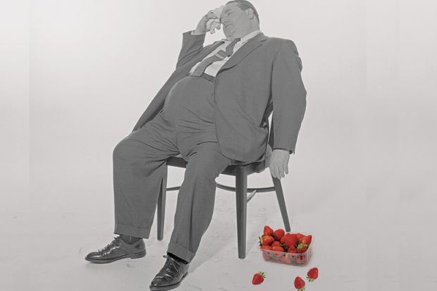 Fat man with punnet of strawberries
