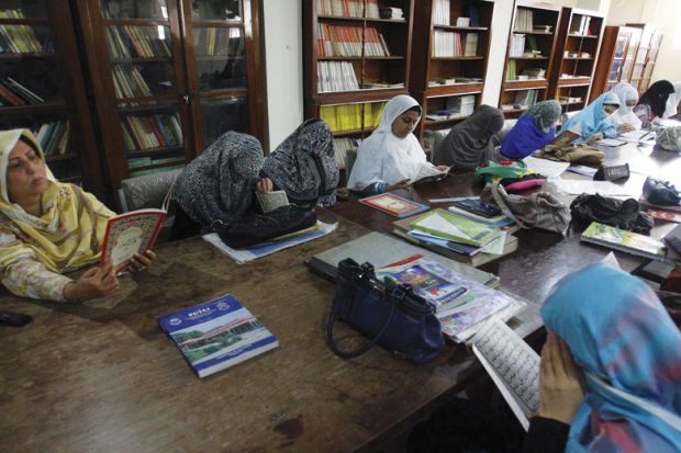 Female students reading in Peshawar University library Female students reading in Peshawar University library