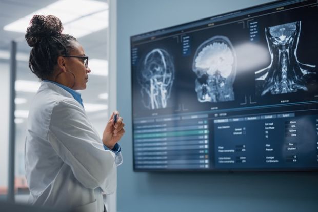 A female doctor looks at an MRI image