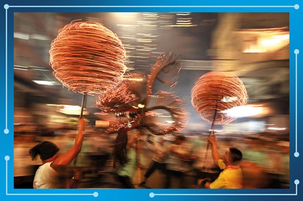 Members of the fire dragon dance team spin balls of joss sticks during the Tai Hang Fire Dragon Dance in Hong Kong. To illustrate Asian universities gathering momentum in the THE World University Rankings. Members of the fire dragon dance team spin balls of joss sticks during the Tai Hang Fire Dragon Dance in Hong Kong. To illustrate Asian universities gathering momentum in the THE World University Rankings.