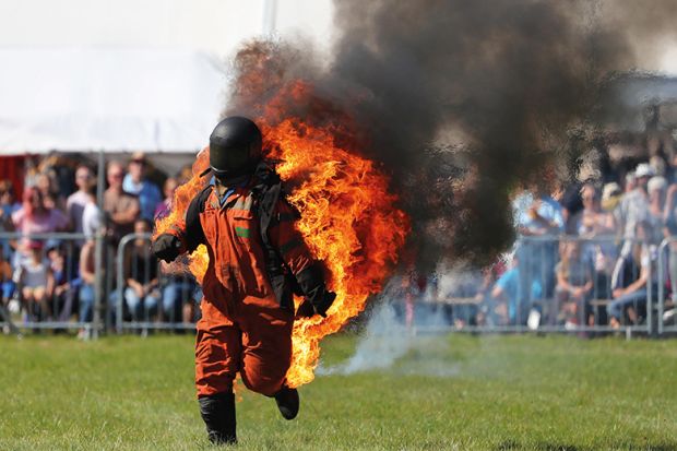 Man in hazard suit on fire