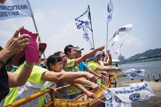 Teammates cheer during a dragon boat race in Taipei Teammates cheer during a dragon boat race in Taipei