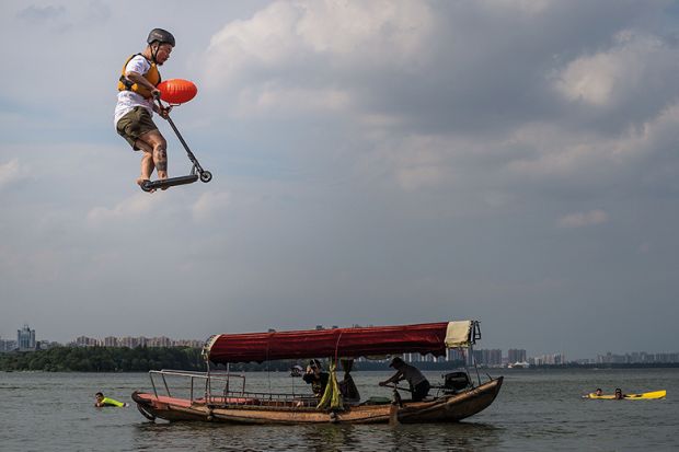 Man on scooter jumps into lake in China
