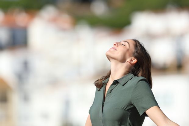 A woman breathes fresh air