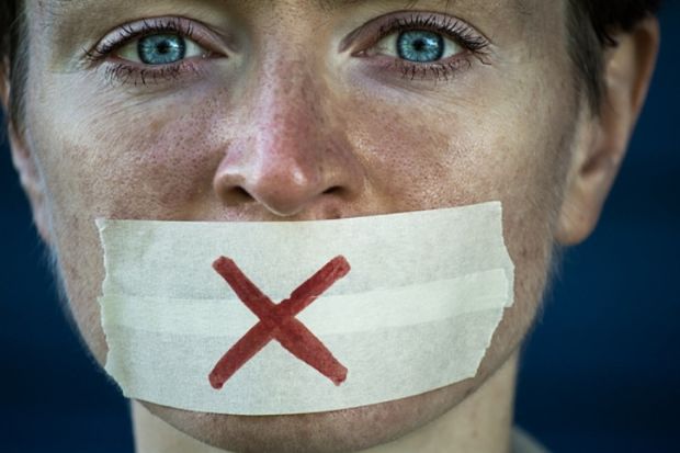 A woman with tape over her mouth symbolising free speech