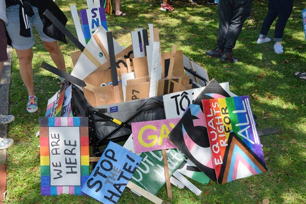 A pile of gay rights placards. To illustrate academia must ‘engage with’ anti-woke research critics.