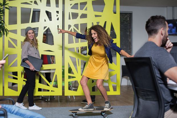 Woman skateboarding in office