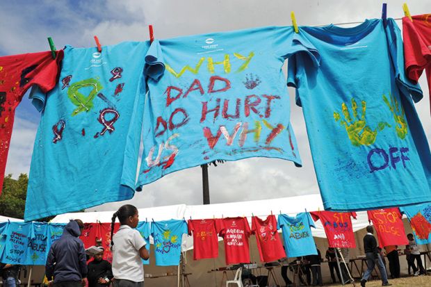 T-shirts painted with messages of support hang on clothes lines, South Africa. Part of the 16 Days of Activism of No Violence Against Women and Children campaign