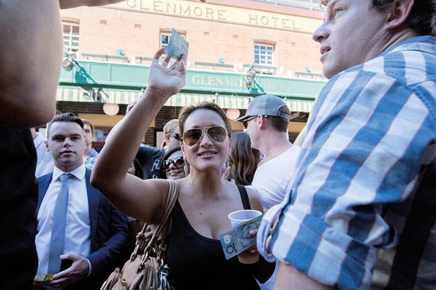 Woman holds Australian dollar notes