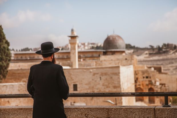 A Jewish man looking at the wailing wall in Jerusalem,Israel. A Jewish man looking at the wailing wall in Jerusalem,Israel.
