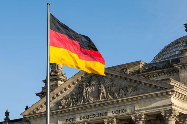  German flag fluttering in front of the Reichstag building in Berlin
