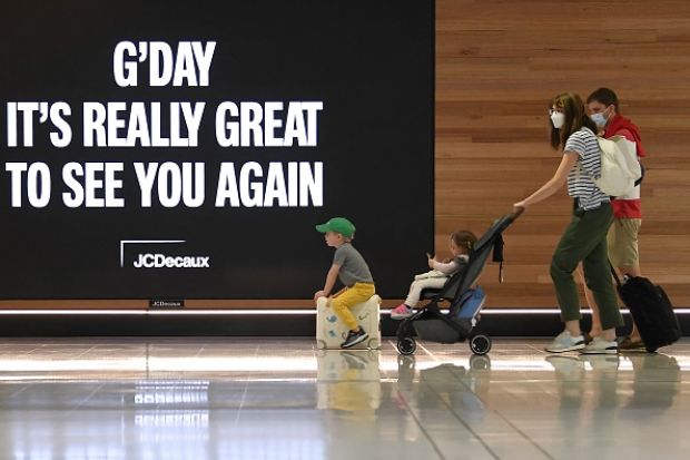 A family leave to board a plane at Sydney's International Airport 