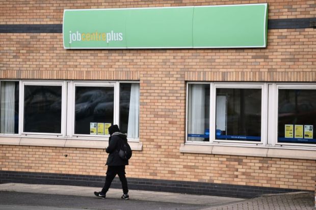 A man walks past a Jobcentre Plus employment office A man walks past a Jobcentre Plus employment office