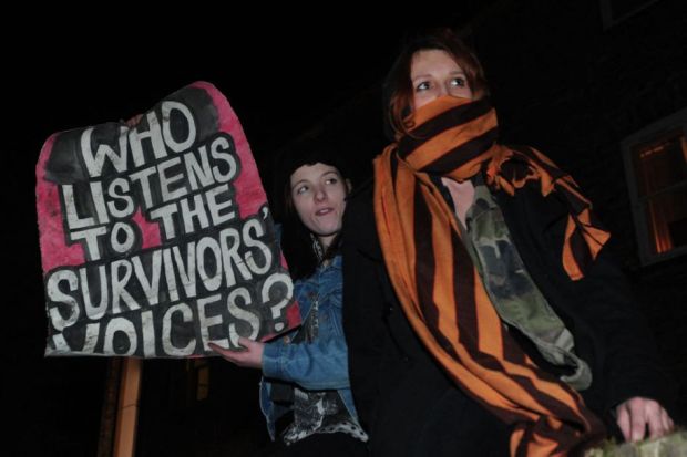 Protesters hold a placard at Cambridge University Union Protesters hold a placard at Cambridge University Union