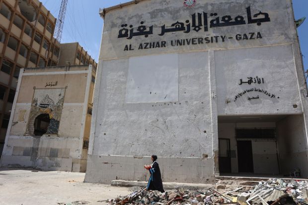 Palestinian researcher Nevin Yassin carries flowers as she walks past rubble after defending her Masters thesis at Al-Azhar University in in Gaza City on May 1, 2025 Palestinian researcher Nevin Yassin carries flowers as she walks past rubble after defending her Masters thesis at Al-Azhar University in in Gaza City on May 1, 2025