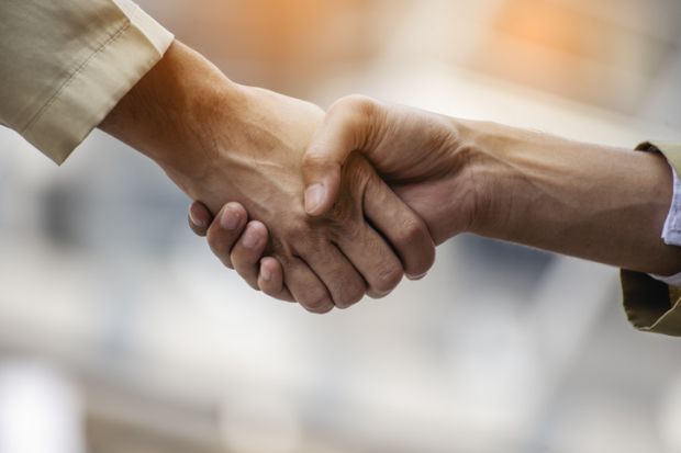 Two people shaking hands Two people shaking hands