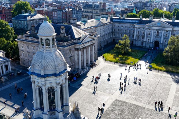 Aerial view of Trinity College Dublin showing a tower in the centre with historic buildings around it
