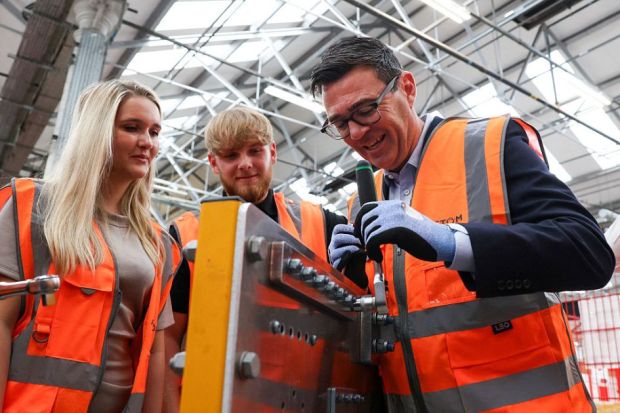 Britain's Prime Minister Andy Burnham uses a ratchet spanner, as he visits French run rail transport systems manufacturer Alstom in Derby Britain's Prime Minister Andy Burnham uses a ratchet spanner, as he visits French run rail transport systems manufacturer Alstom in Derby