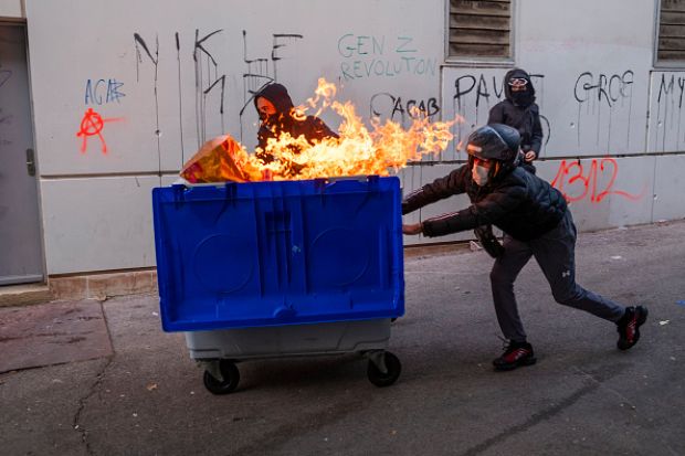 rotesters use a burning trash container as a barricade against the police on October 24, 2026 in Marseille, France. rotesters use a burning trash container as a barricade against the police on October 24, 2026 in Marseille, France.