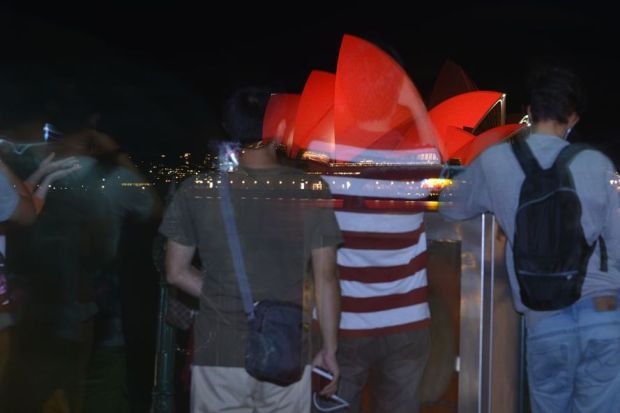 This long exposure photograph shows Chinese tourists taking photos in front of the Sydney Opera House which is lit up red to welcome in the Lunar New Year of the Monkey in Sydney on February 8, 2016. This long exposure photograph shows Chinese tourists taking photos in front of the Sydney Opera House which is lit up red to welcome in the Lunar New Year of the Monkey in Sydney on February 8, 2016.