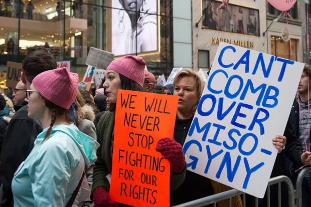 Participants at the Women's March in New York City on January 21, 2017. The placard at centre refers to US President Donald Trump and reads: 'Can't comb over misogyny'
