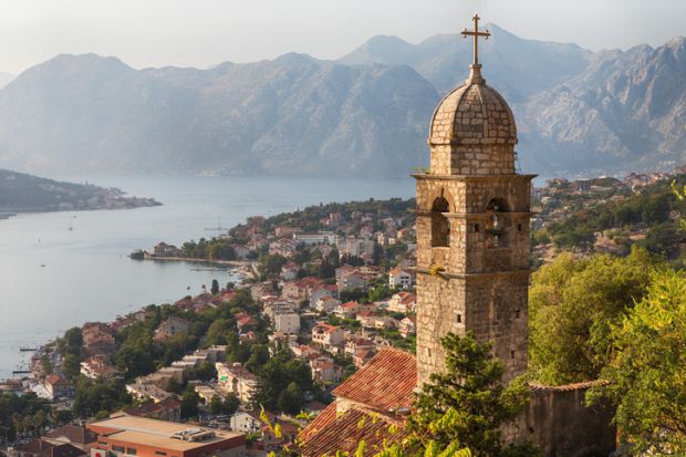 A church tower perched on a slope in sunny Montenegro