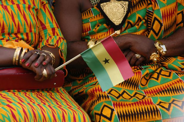 Women in kente dresses with Ghana flag