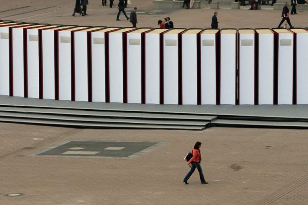 Visitors walk past giant books at the Frankfurt Book Fair. Germany Visitors walk past giant books at the Frankfurt Book Fair. Germany