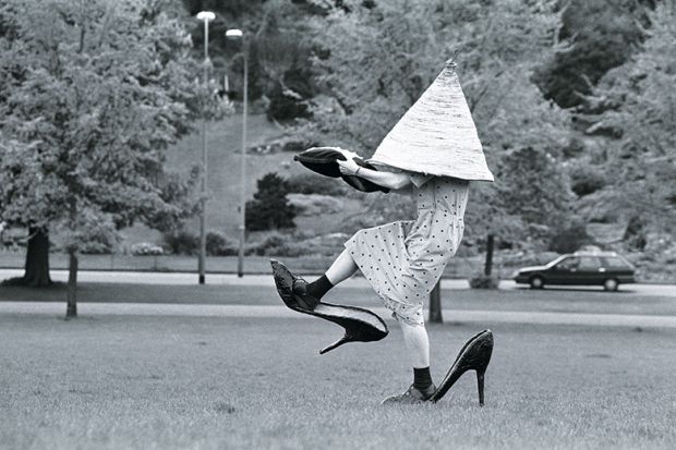 Woman in giant shoes and hat
