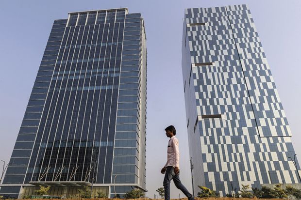A pedestrian walks past 2 buildings in Gujarat International Finance Tec-City (GIFT City), Gujarat, India A pedestrian walks past 2 buildings in Gujarat International Finance Tec-City (GIFT City), Gujarat, India
