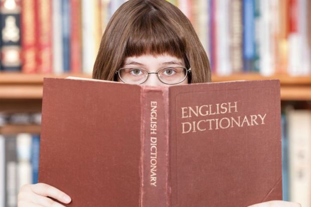 Girl looking over dictionary