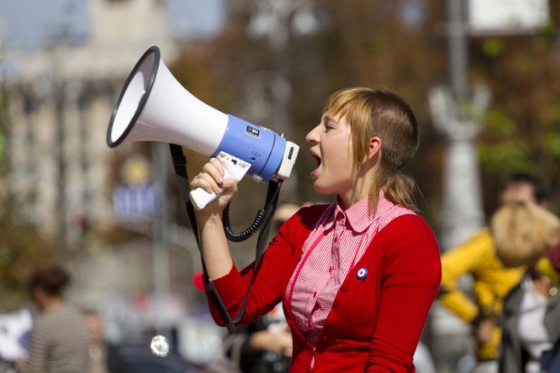 Girl shouts in a megaphone