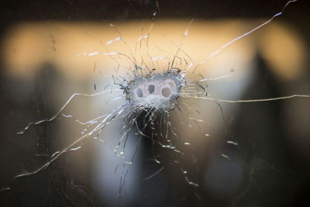 Glass with bullet holes