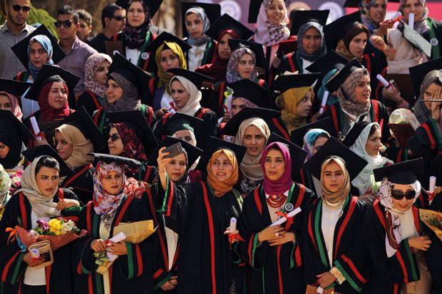 Libyan pharmacy students pose for a selfie during their graduation ceremony at the Al-Arab University in Benghazi, 2016