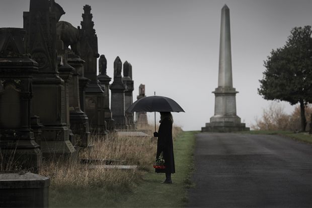 Woman looking at graves