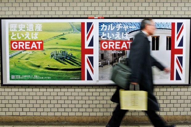 Pedestrian walks past 'GREAT' campaign posters