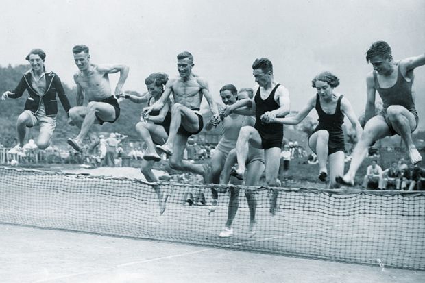 People jumping over tennis net