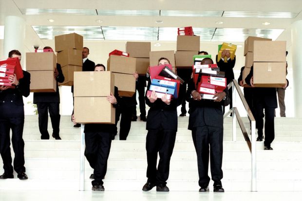 Group of businessmen carrying boxes from office